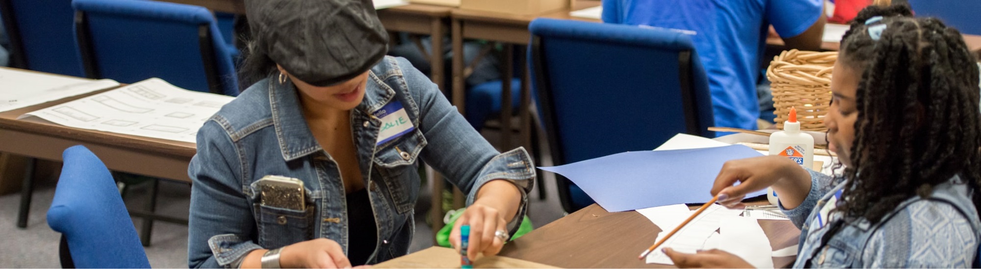 A girl and a woman doing arts and craft activities.